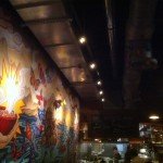 A 9-by-28-foot mural of a painting by Mike "Pooch" Pucciarelli spans one entire wall at Kapow! in Boca Raton.