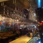 A view of the dining room and open kitchen from the side of the bar.
