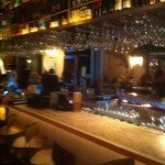 To save space, the glassware and liquor bottles are stored above the bar at Kapow! in Boca Raton.