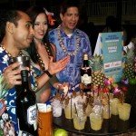 The Mai-Kai's Navind Boodoo pours the Pupule Punch, while Molokai Girl Roxy Centera and manager Kern Mattei prepare to serve the eager guests.