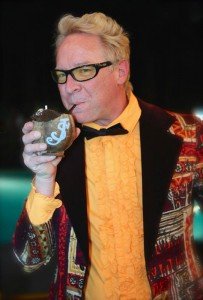 Host Shag enjoys a cocktail during the poolside Modernism Week party held Feb. 12 at the Caliente Tropics Resort Hotel. (Photo by Kari Hendler from Poly Hai)