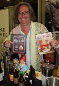 Mixologist and author Warren Bobrow, representing Stroh, shows off some of his books.